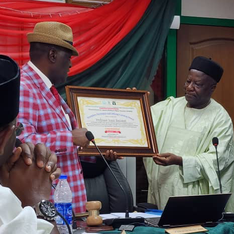 The facilitator-General of the institute, Prof. Peter Okebukola, presenting the Exemplary Participant and Lifelong Learning Award to Prof. Butswat