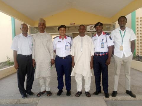 Gana (3rd Left) in a group photograph with staff and the visiting team