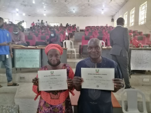 Husband and Wife displaying their Certificate